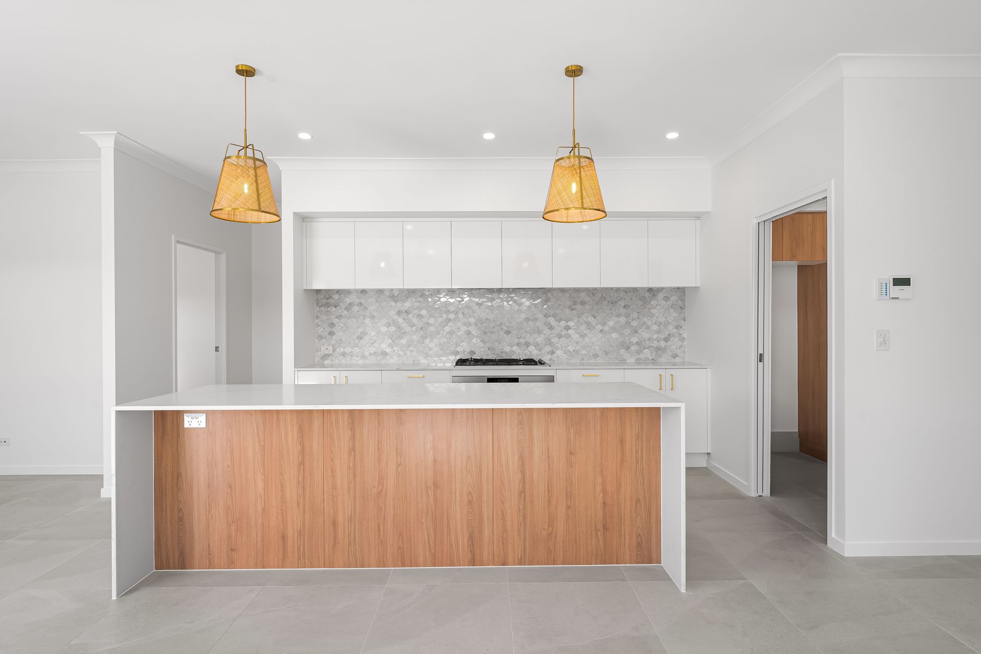 Modern kitchen with stainless steel appliances and red glass splashback