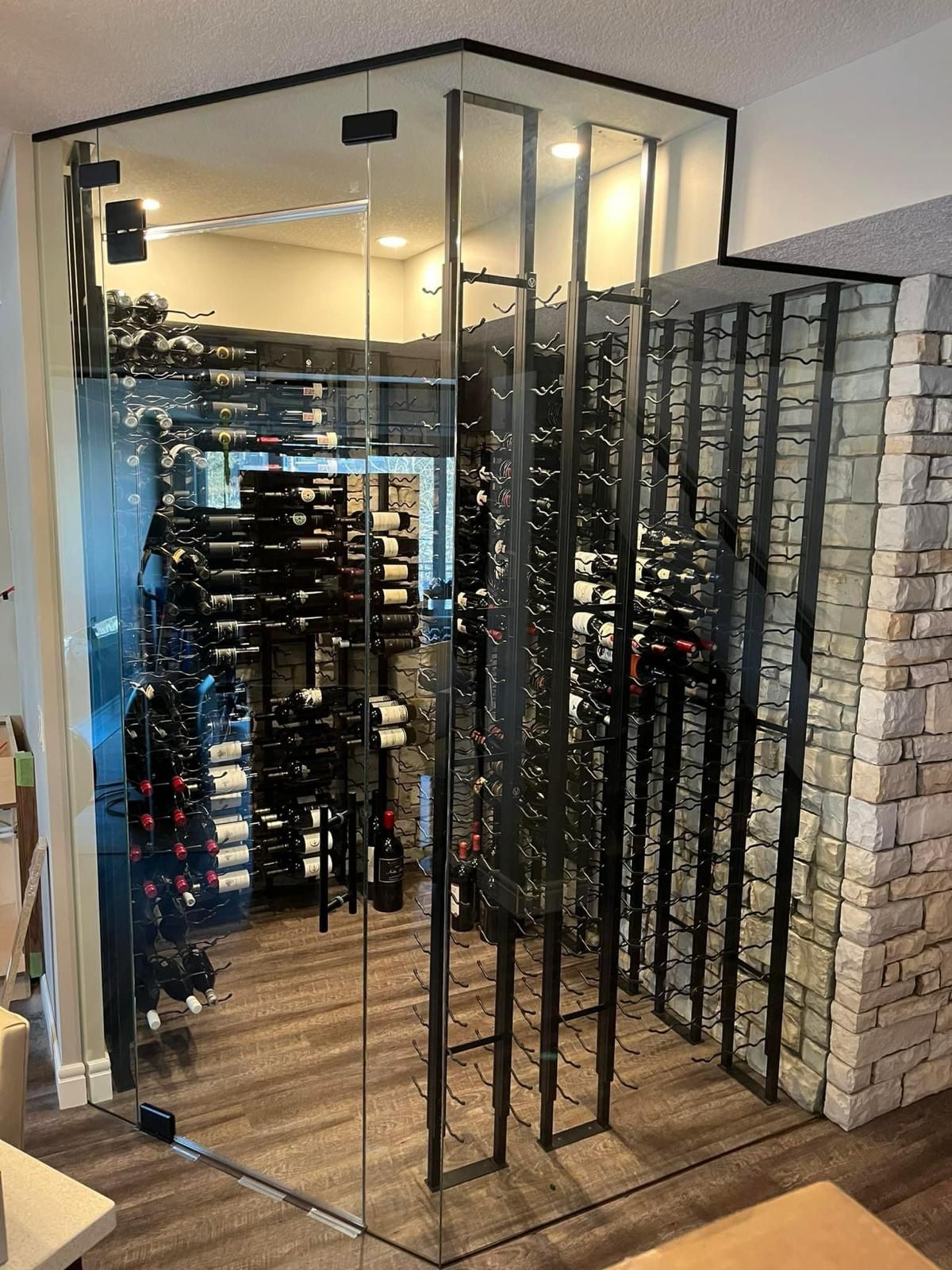 Stylish glass enclosure for a wine cellar, designed to keep wine at optimal temperatures.