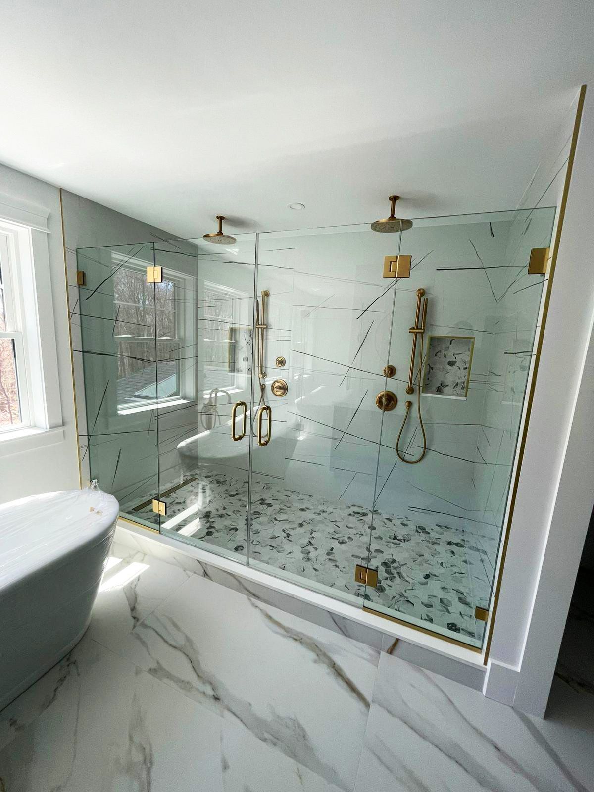 Shower glass doors providing a contemporary touch.