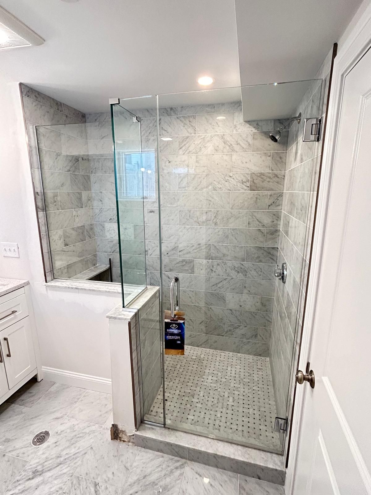 Stylish bathroom featuring a walk-in shower with clear glass walls