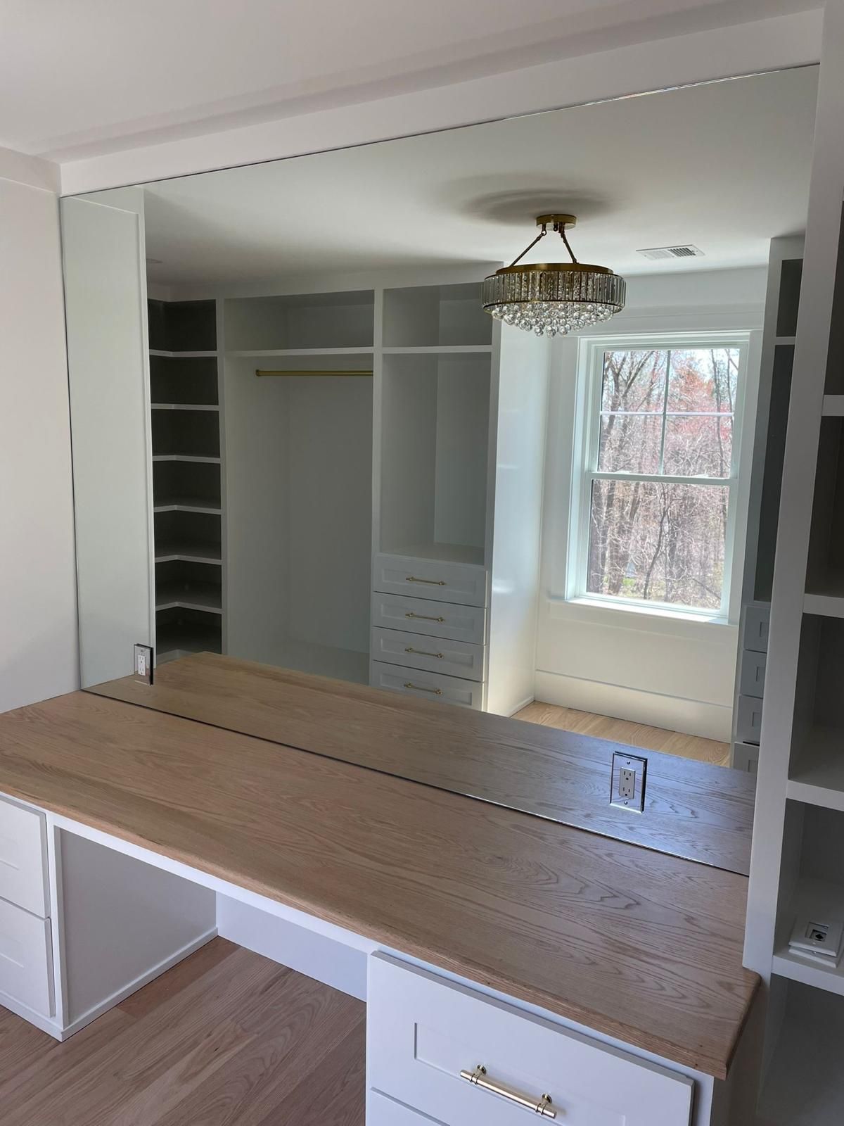 Mirror on a vanity, enhancing the beauty of the space.