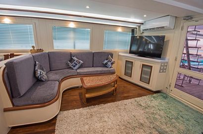 A Living Room With a Couch, Table, and Television — Custom Unique Trimming in Mackay, QLD