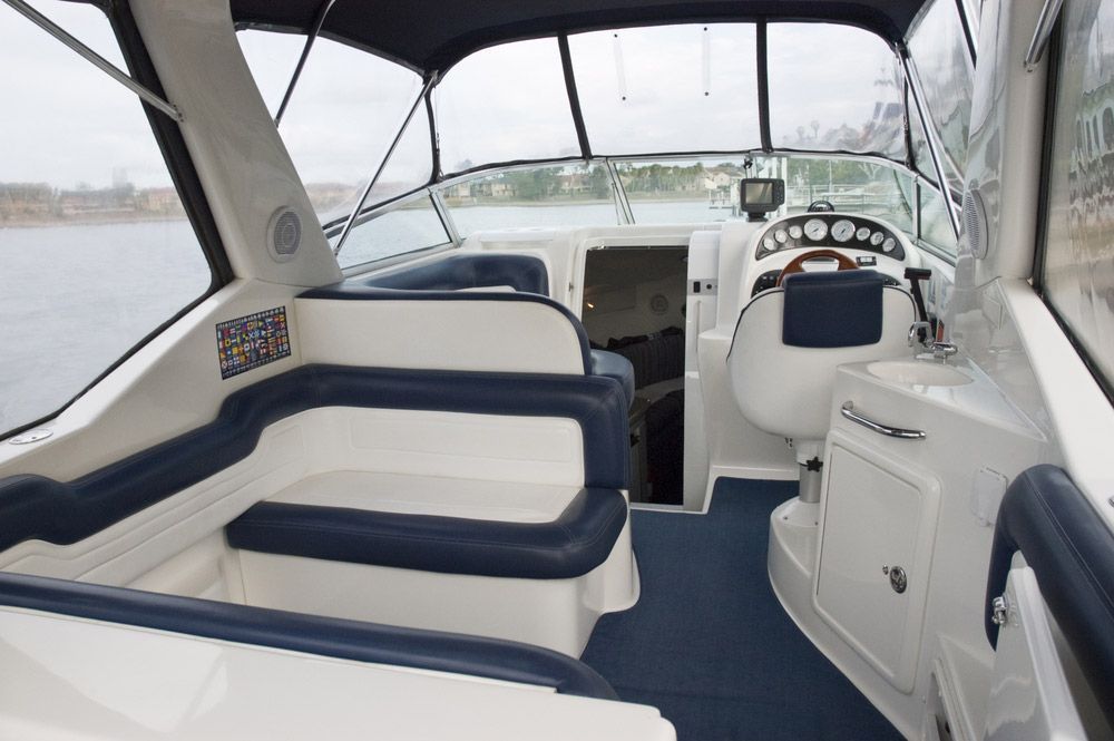 The Inside of a Boat With Blue and White Seats and a Steering Wheel — Custom Unique Trimming in Mackay, QLD