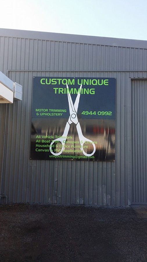 A Sign on the Side of a Building That Says Custom Unique Trimming — Custom Unique Trimming in Mackay, QLD