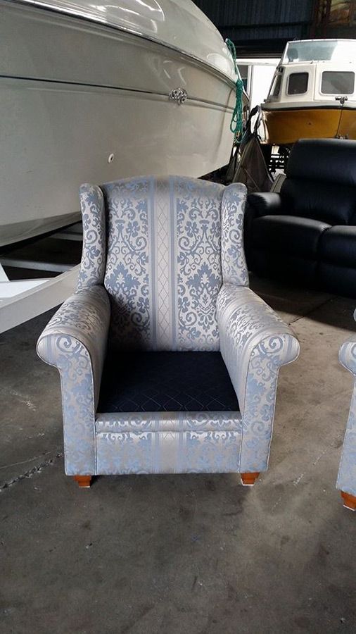 A Chair is Sitting in a Warehouse Next to a Boat — Custom Unique Trimming in Mackay, QLD