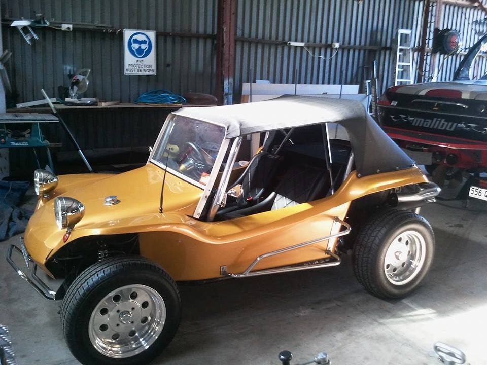 A Yellow Buggy is Parked in a Garage Next to a Boat — Custom Unique Trimming in Mackay, QLD