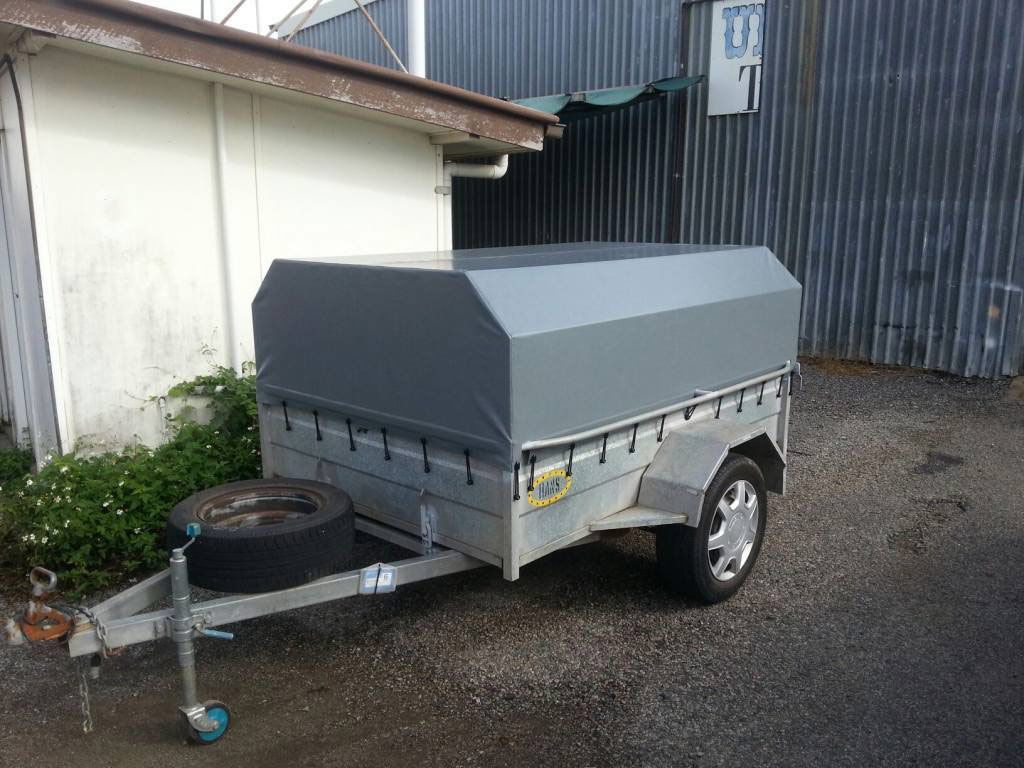 A Small Trailer is Parked in Front of a Building — Custom Unique Trimming in Mackay, QLD