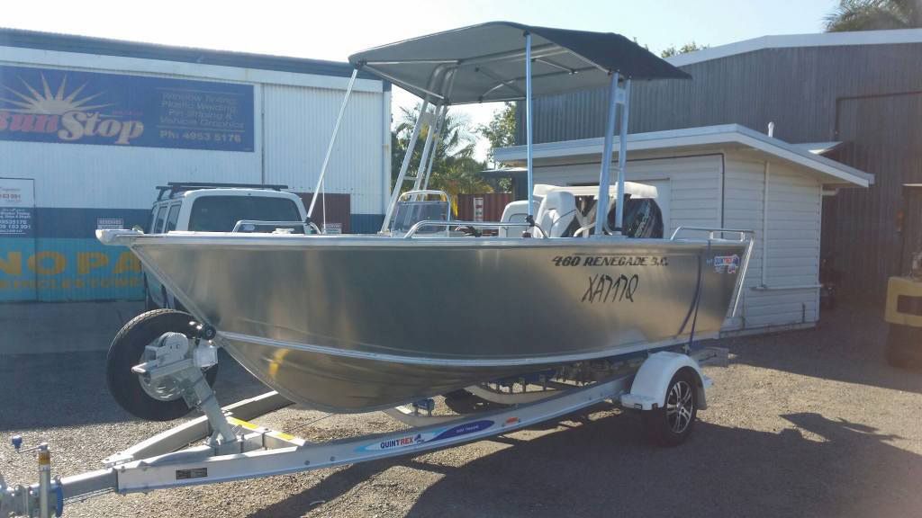 A Boat on a Trailer is Parked in Front of a Building — Custom Unique Trimming in Mackay, QLD