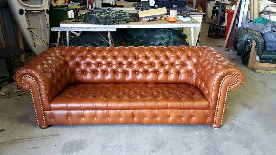 A Brown Leather Couch is Sitting in a Garage — Custom Unique Trimming in Mackay, QLD