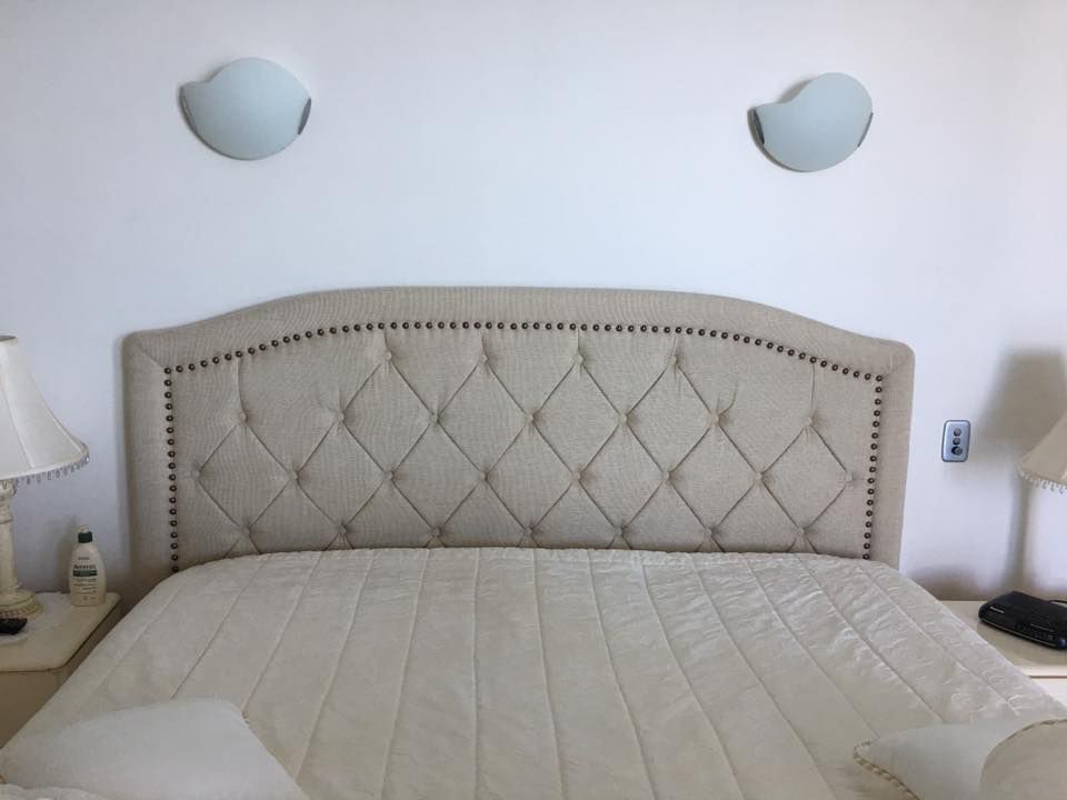 A Bed With a Tufted Headboard in a Bedroom — Custom Unique Trimming in Mackay, QLD