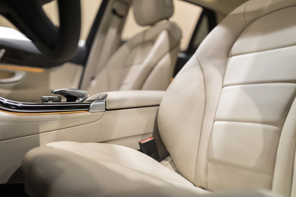 A Close Up of a Car Seat With a Steering Wheel in the Background — Custom Unique Trimming in Mackay, QLD