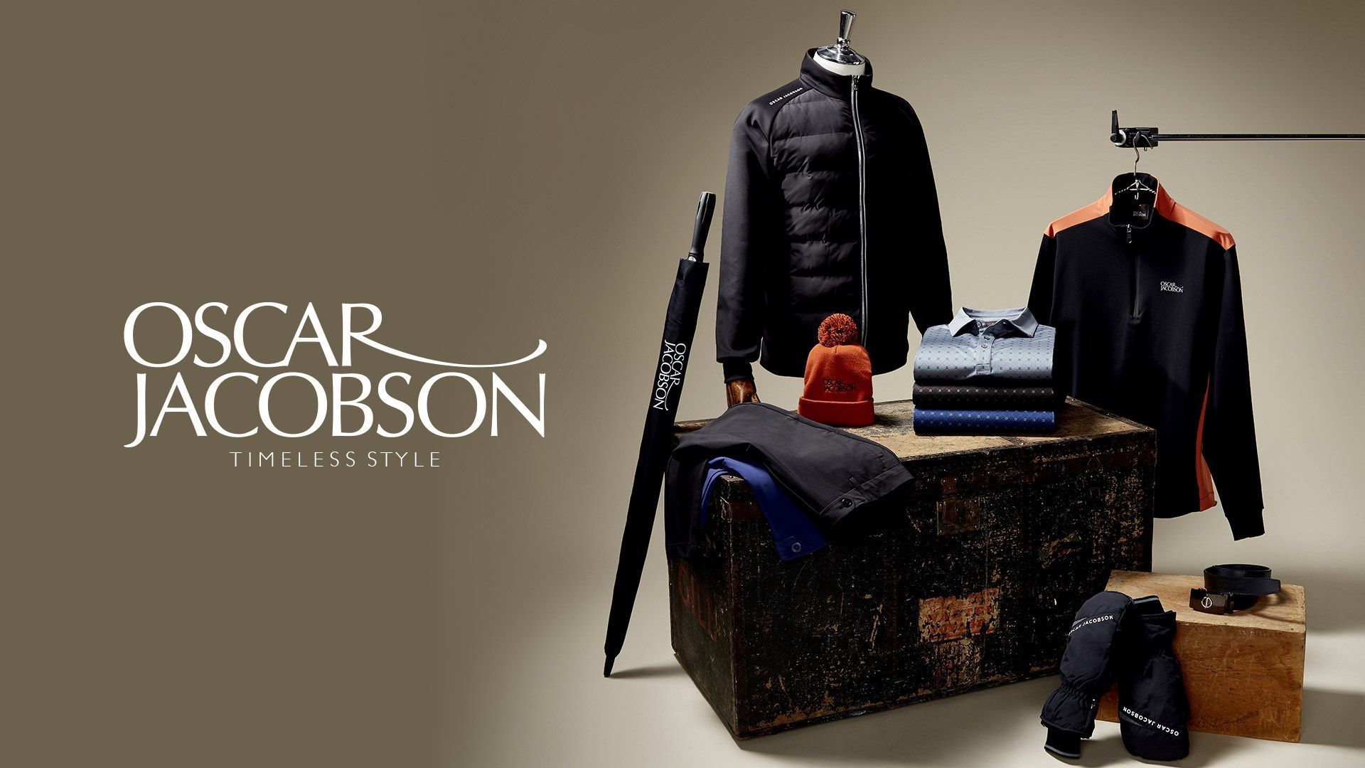 An ad for oscar jacobson shows a trunk full of clothing