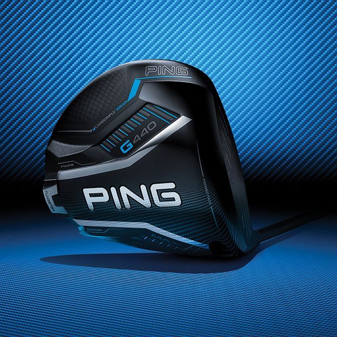 A ping golf club is sitting on a blue surface.