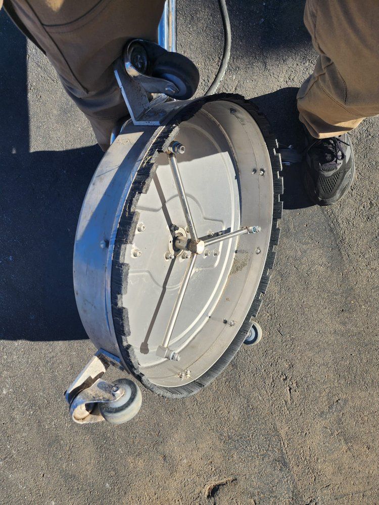 A person is standing next to a circular object with wheels on it.