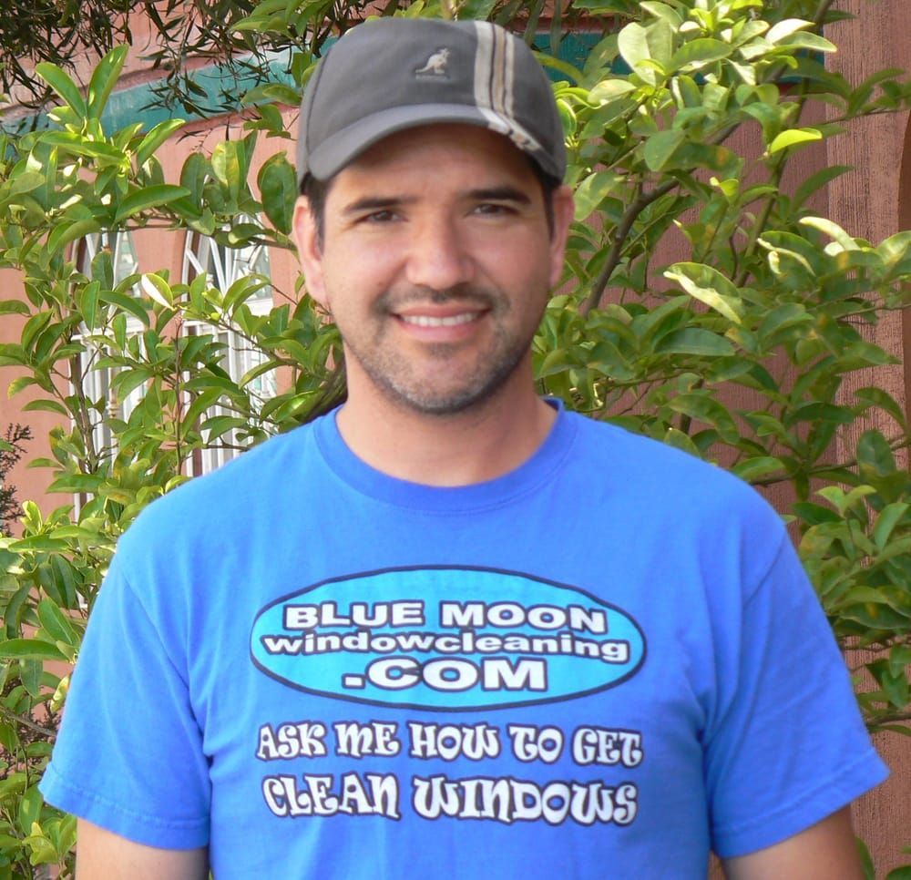 A man wearing a blue moon window cleaning shirt