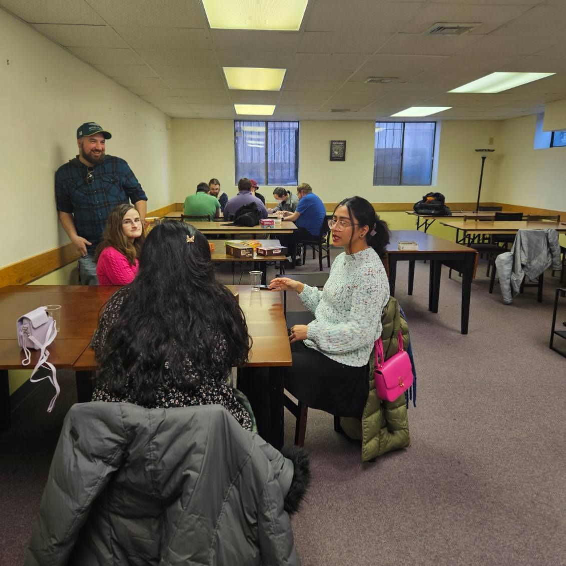 A group of people are sitting at tables in a room