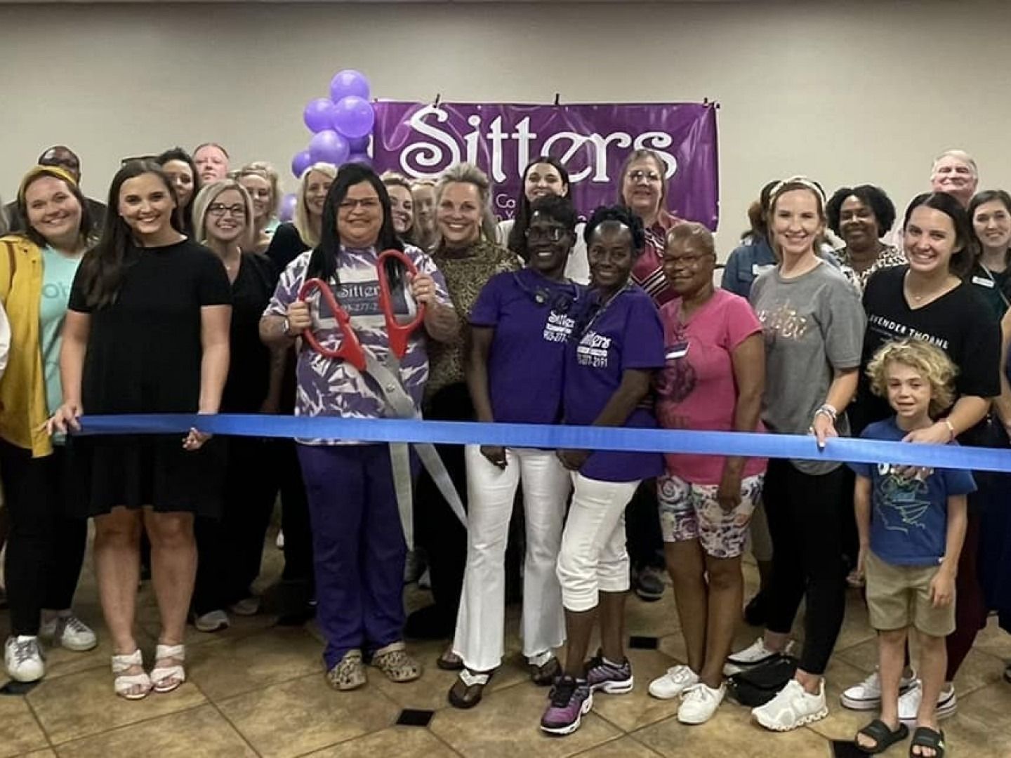 Group cuts blue ribbon at
