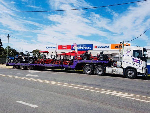 Truck Carrying Machinery — Gympie Towing in Kybong, QLD