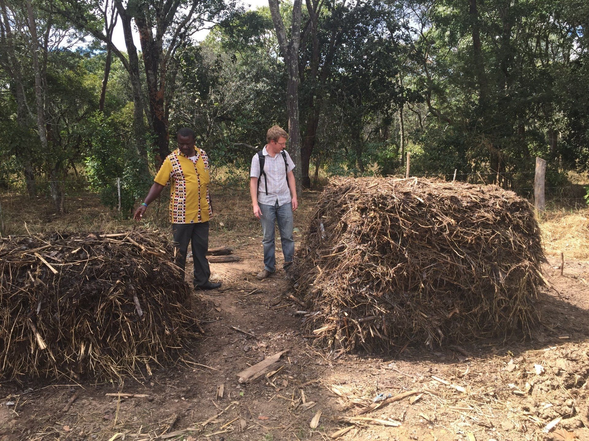 two men stood between two composing piles