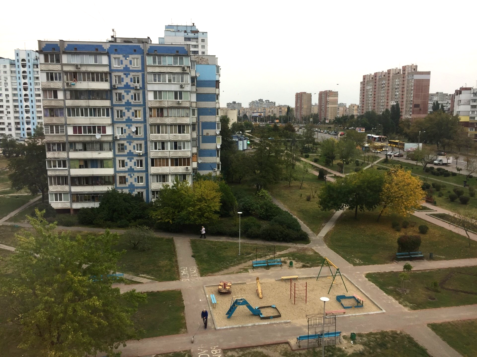 View of city including flat blocks and a park with a playground