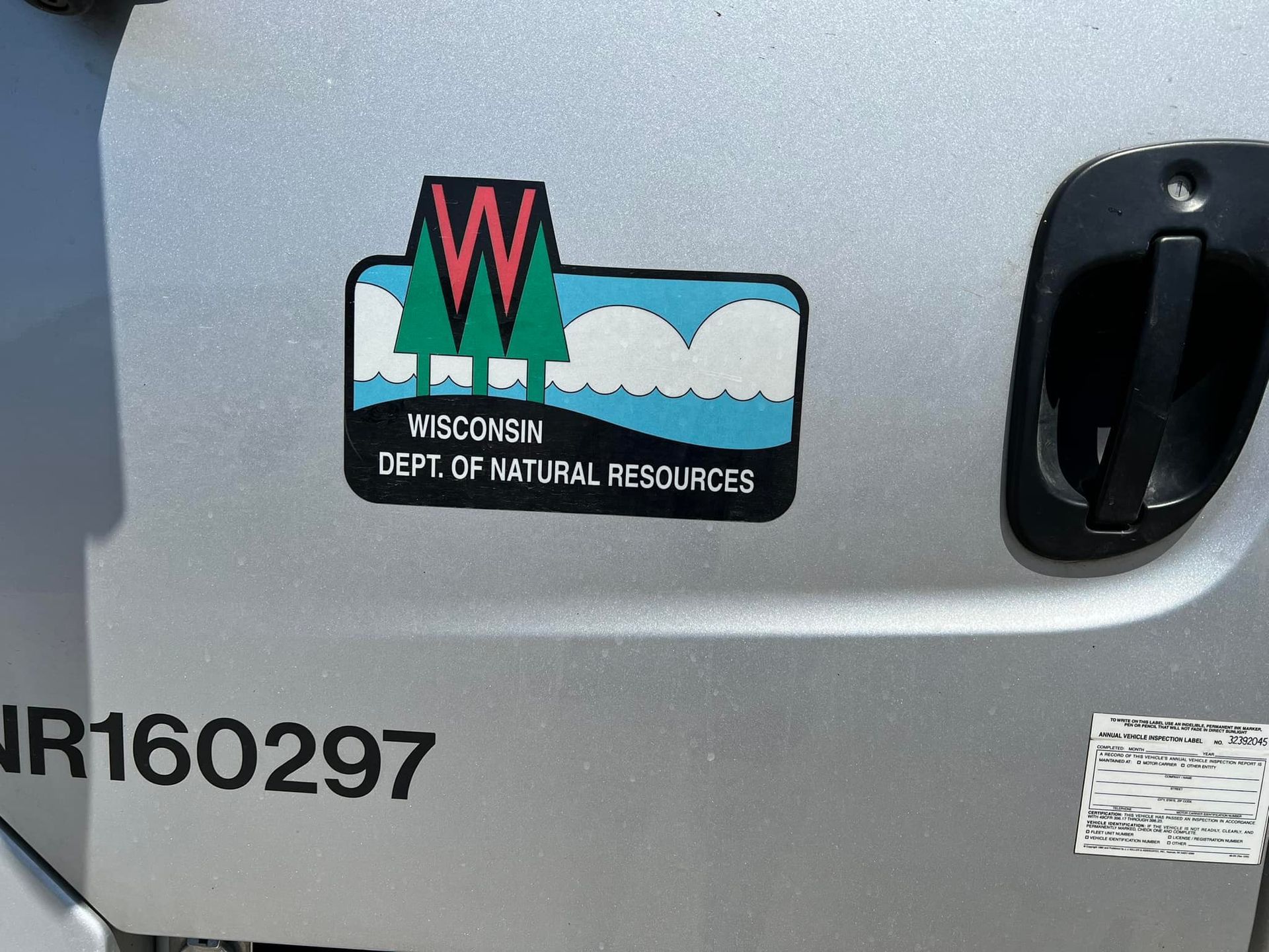 A sticker on the side of a vehicle says wisconsin department of natural resources