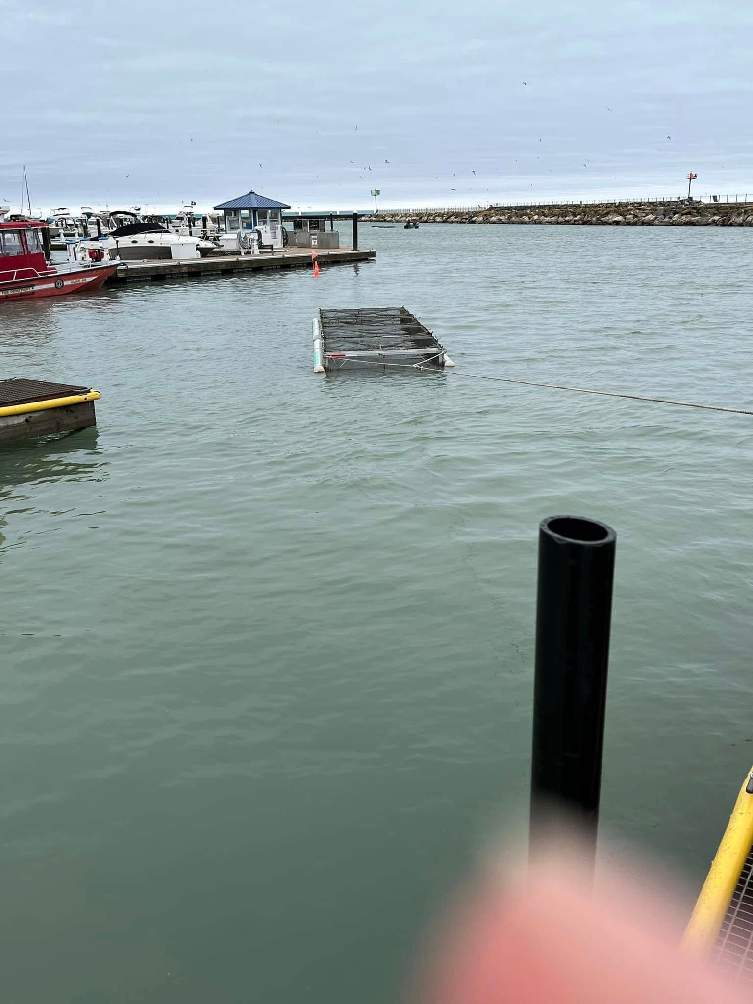 A boat is floating in the water near a dock.