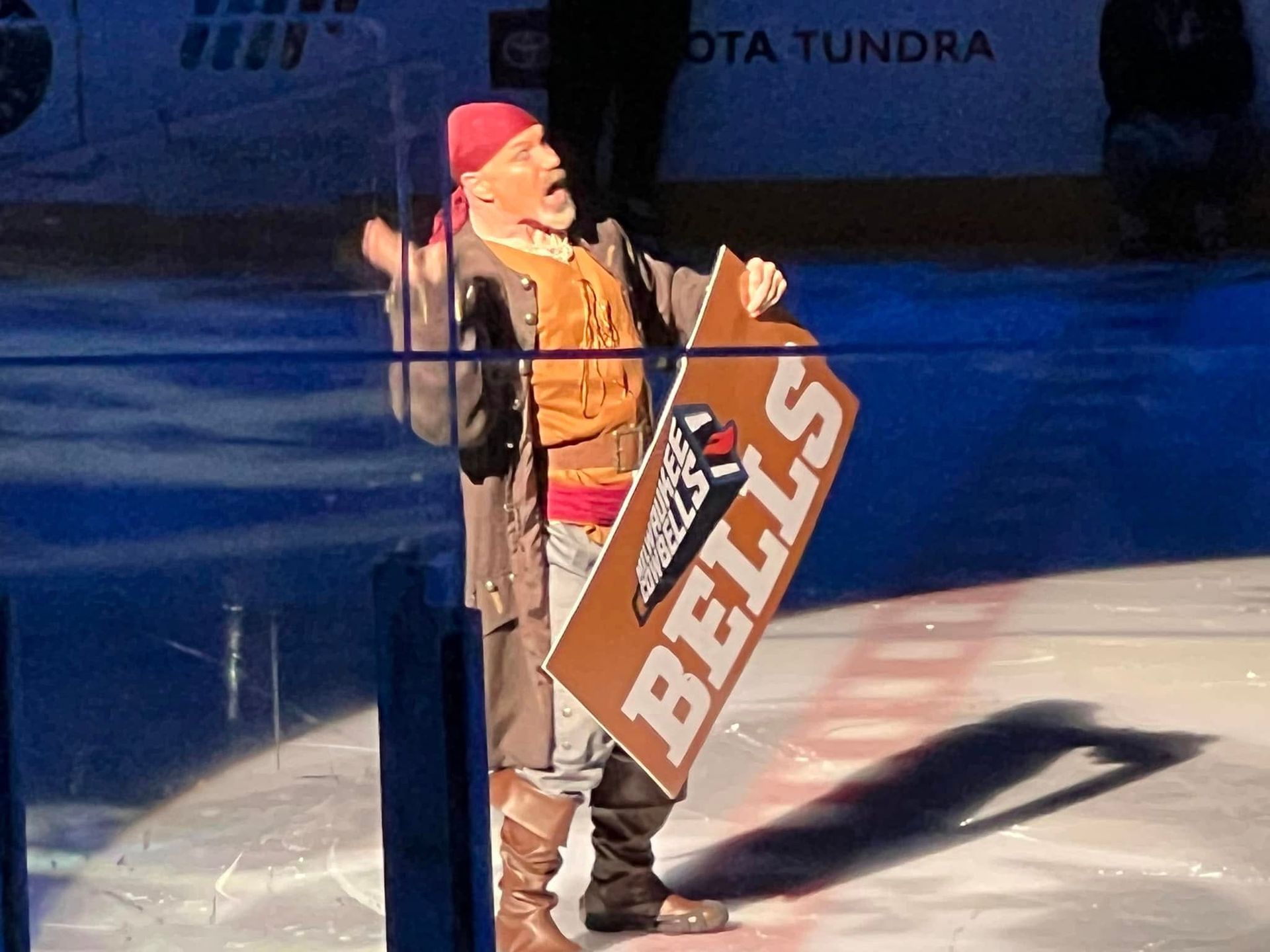 A man holding a sign that says bells on it