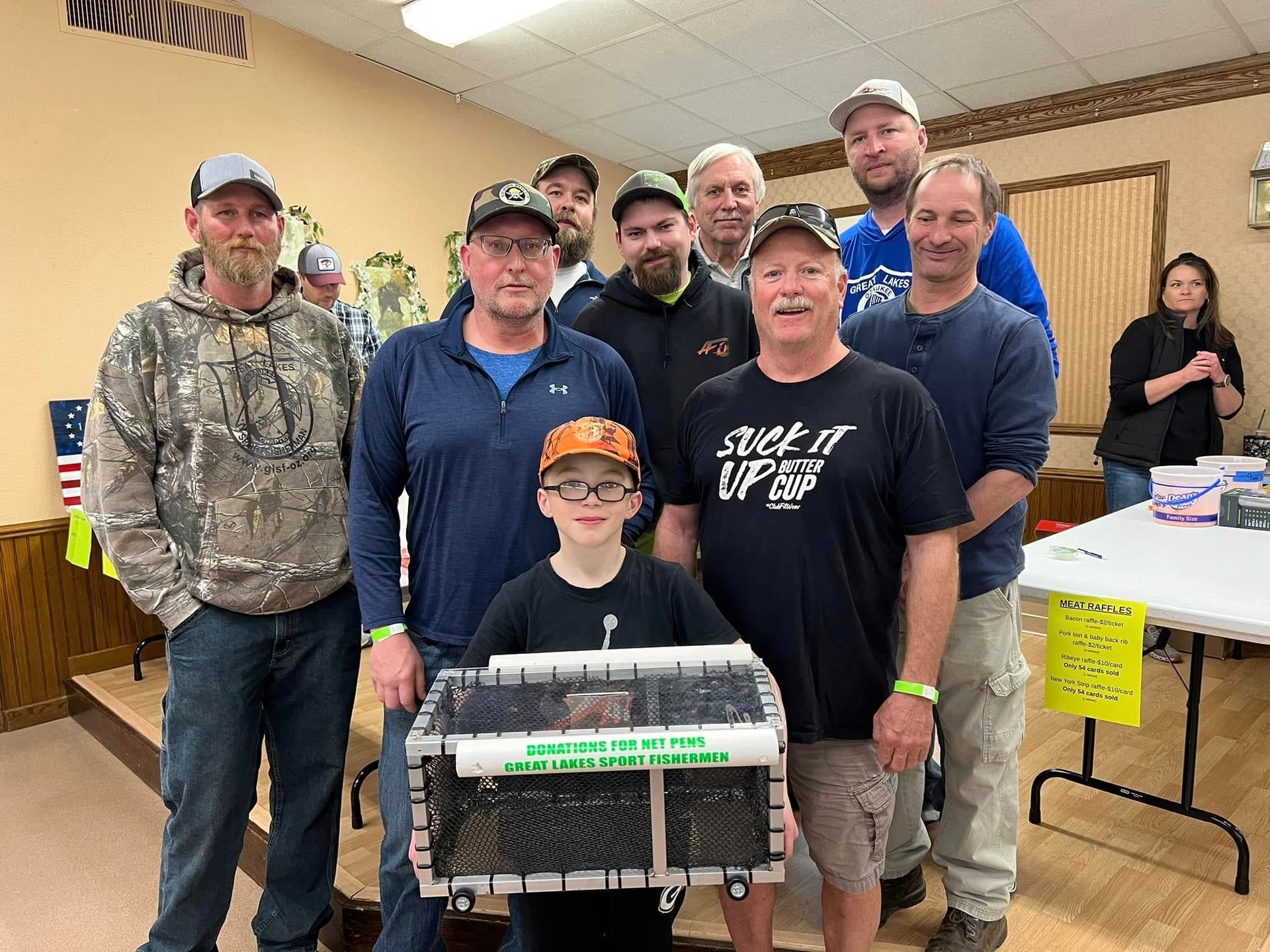 A group of men and a boy are posing for a picture in a room.