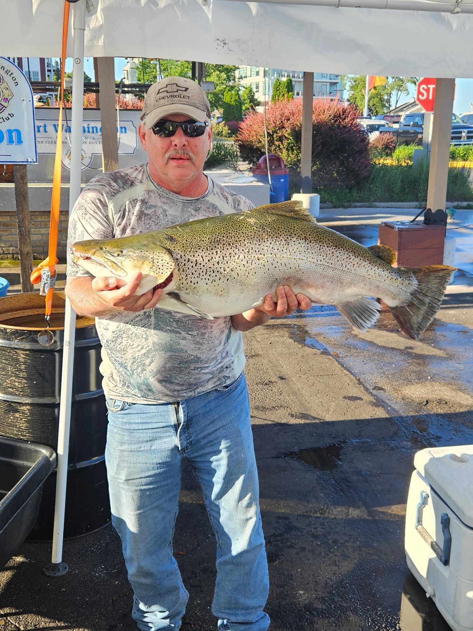 A man is holding a large fish in his hands