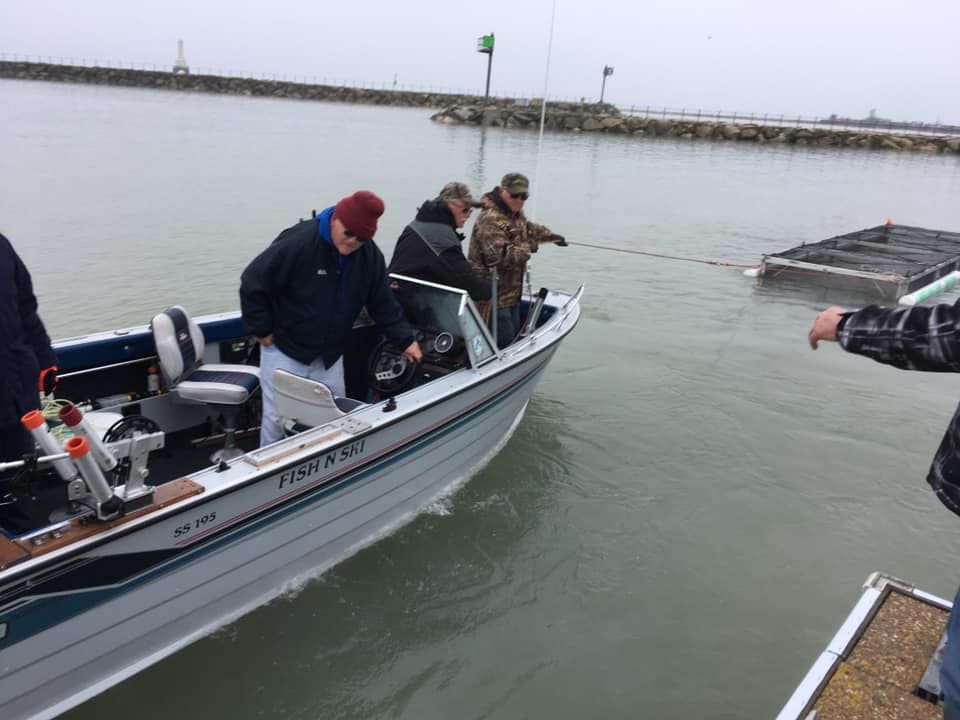 A group of men are in a boat in the water.