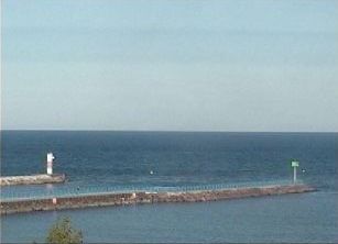 A large body of water with a lighthouse in the distance.