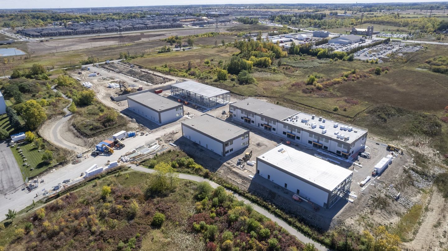 An aerial view of a large industrial area with lots of buildings and trees.