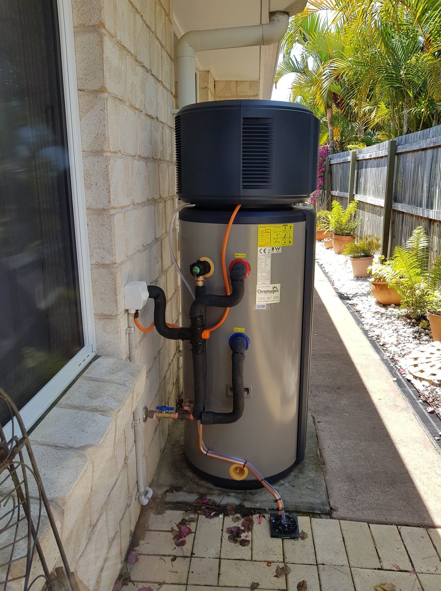 Heat Pump Water Heater Installed Outside a Building on a Concrete Pad — 24/7 Hot Water in Valdora, QLD