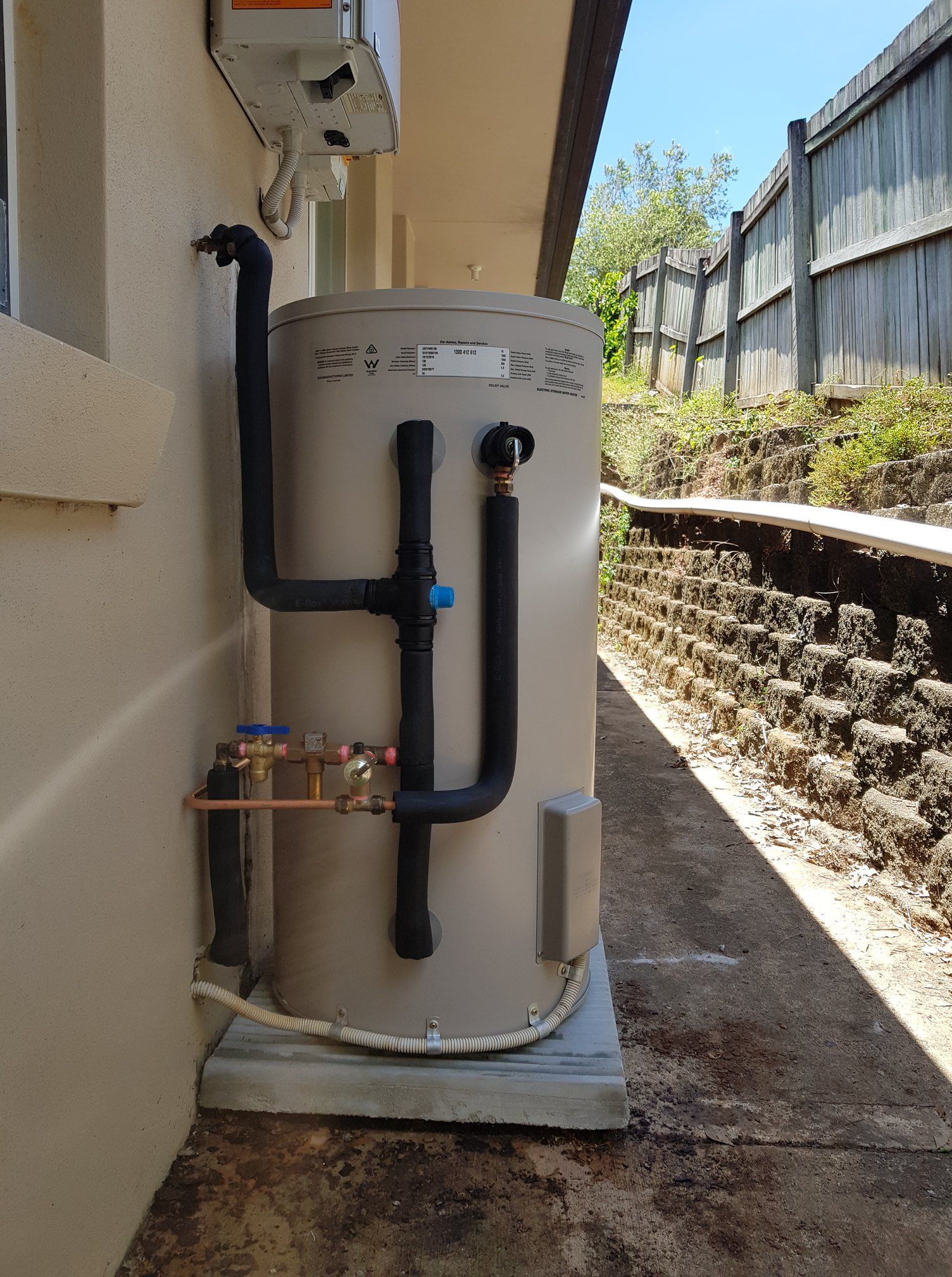 Hot Water Tank Against a Building — 24/7 Hot Water in Gympie, QLD