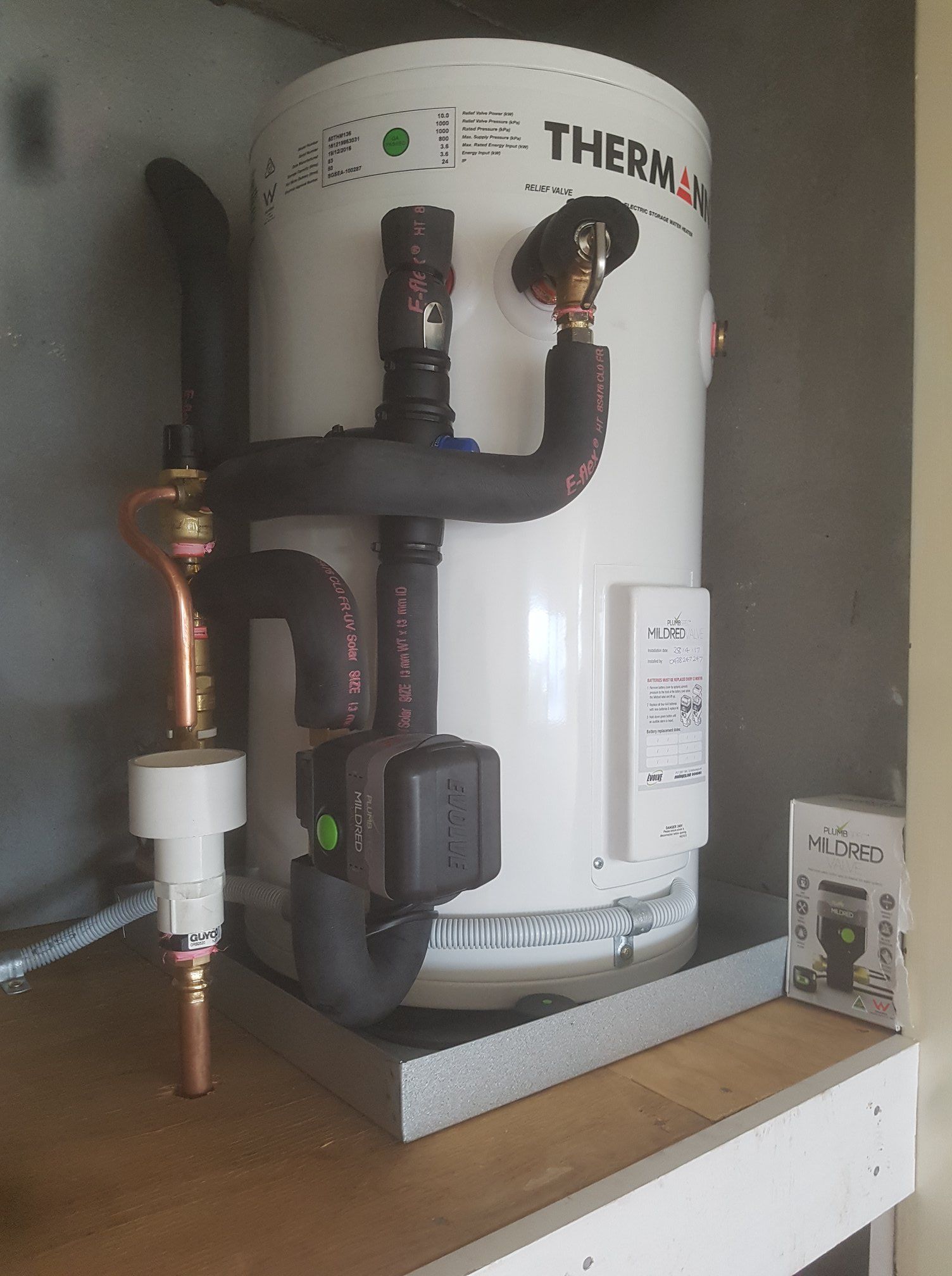 White Water Heater With Black Pipes and Copper Fittings in a Cabinet — 24/7 Hot Water in Caloundra, QLD