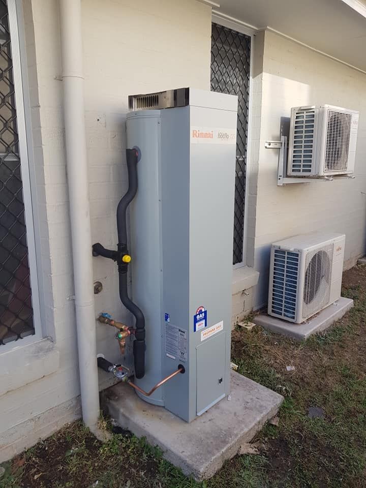 A Tall, Gray Rinnai Hot Water System Outside a House — 24/7 Hot Water in Maroochydore, QLD