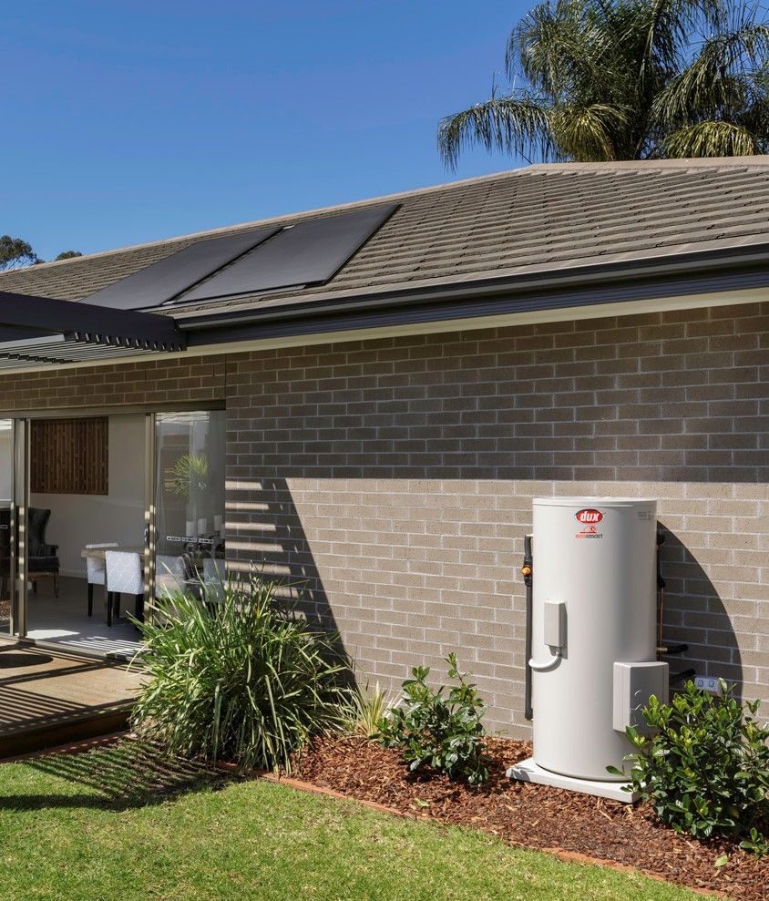 A Large Water Heater Tank With Black Insulated Pipes Attached — 24/7 Hot Water in Valdora, QLD