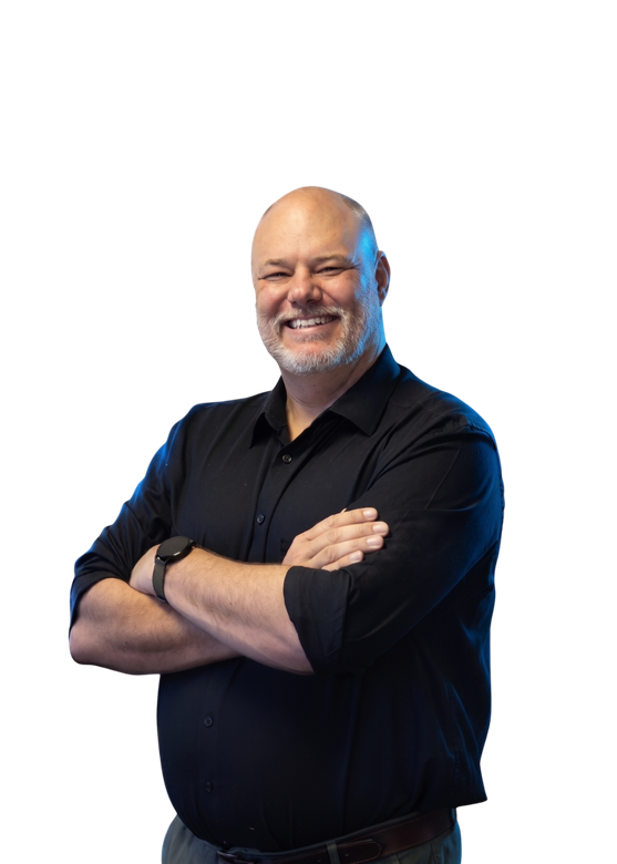 Smiling bald man in a black shirt with arms crossed against a white background