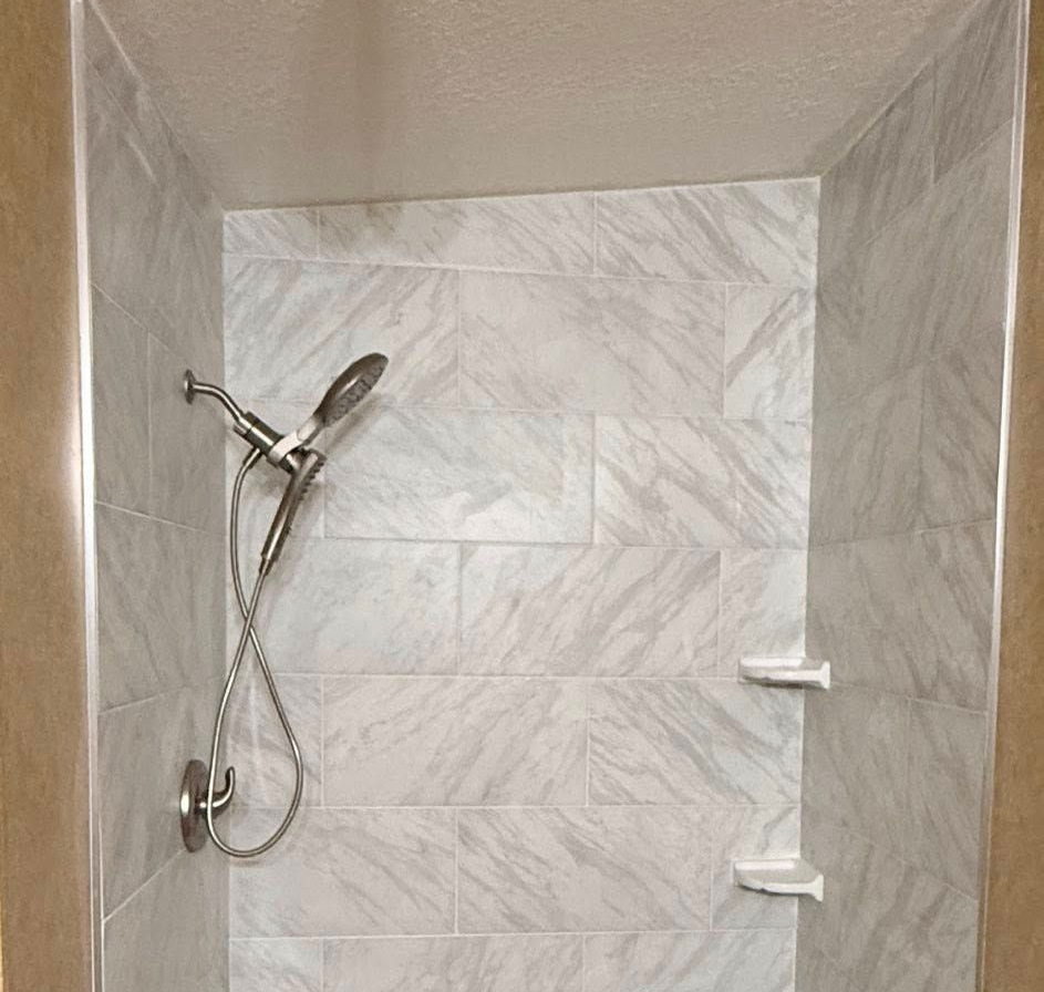 A professional reviews a floor plan sketch with a couple at a table.