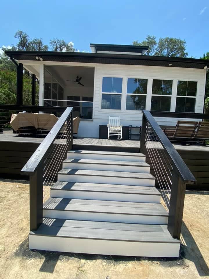 A professional reviews a floor plan sketch with a couple at a table.