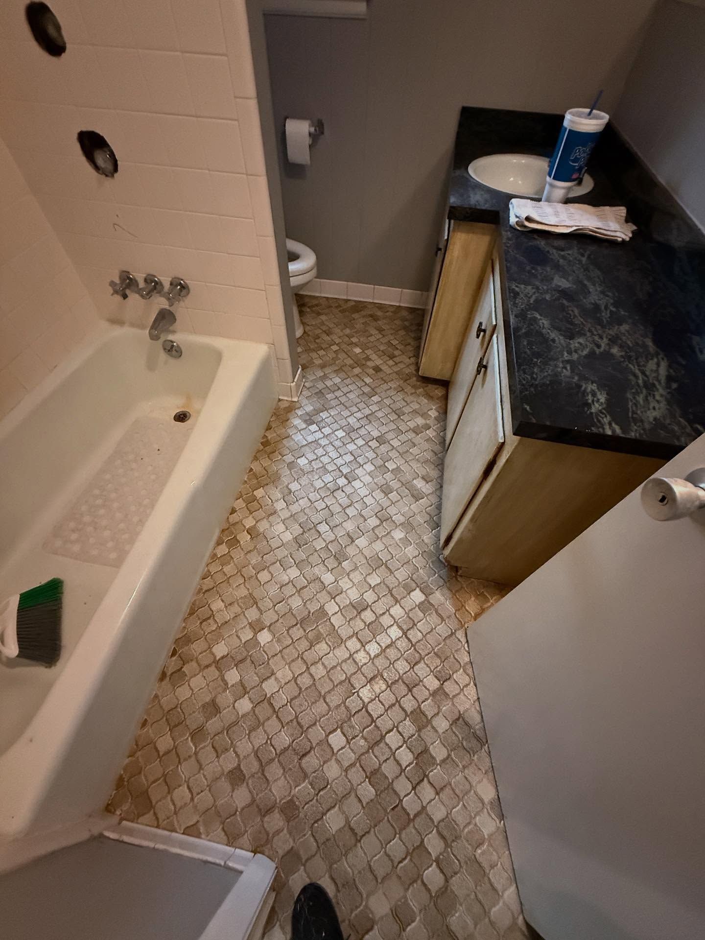 A professional reviews a floor plan sketch with a couple at a table.