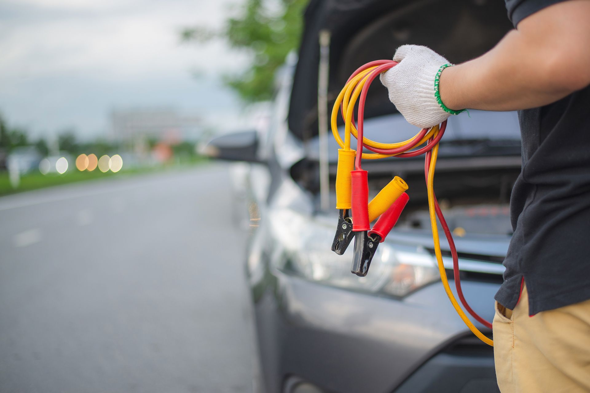 Man Holding a Pair of Jump Cables