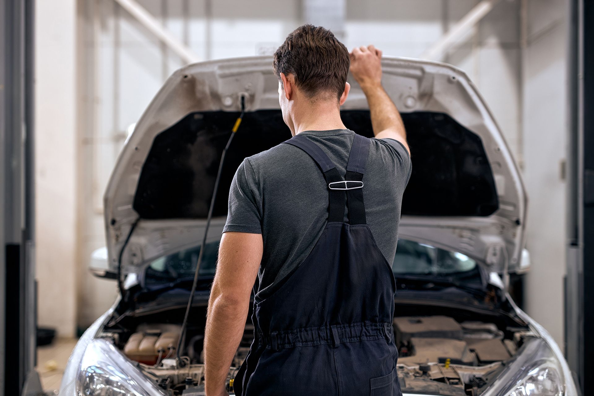 Mechanic Standing in Front of a Car