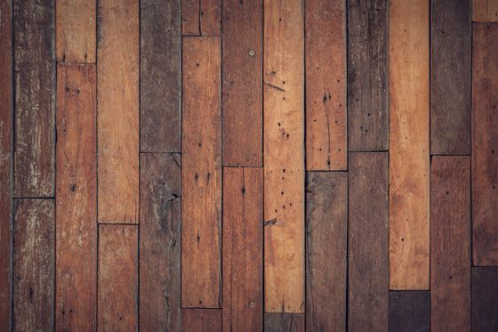 A close up of a wooden floor with a row of wooden planks.