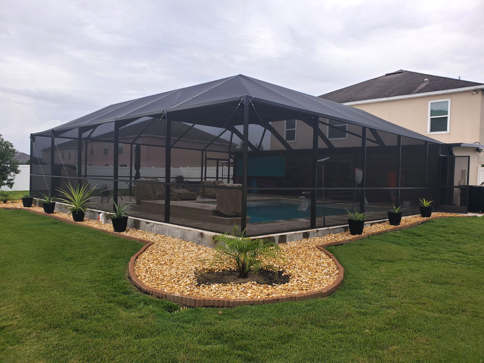 custom bronze hip roof pool enclosure with a split maintenance in Lakeland, FL.