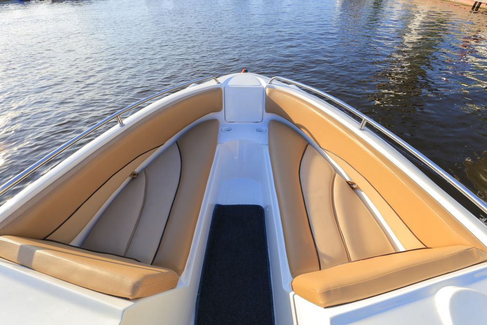A White Boat With Tan Seats is in the Water — Furniture & Auto Pride In Port Macquarie, NSW