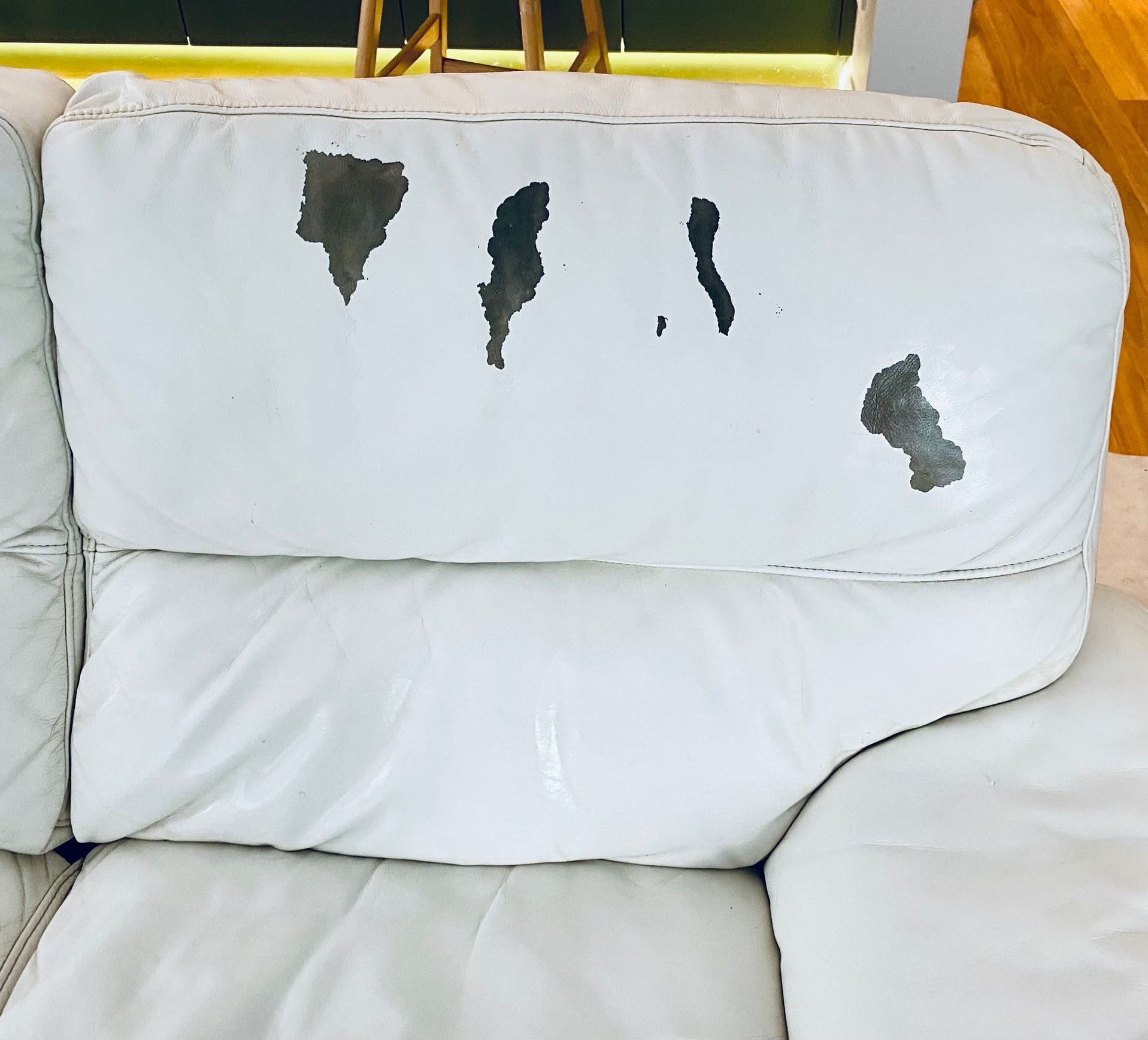 A white leather couch with holes in it — Furniture & Auto Pride In Port Macquarie, NSW