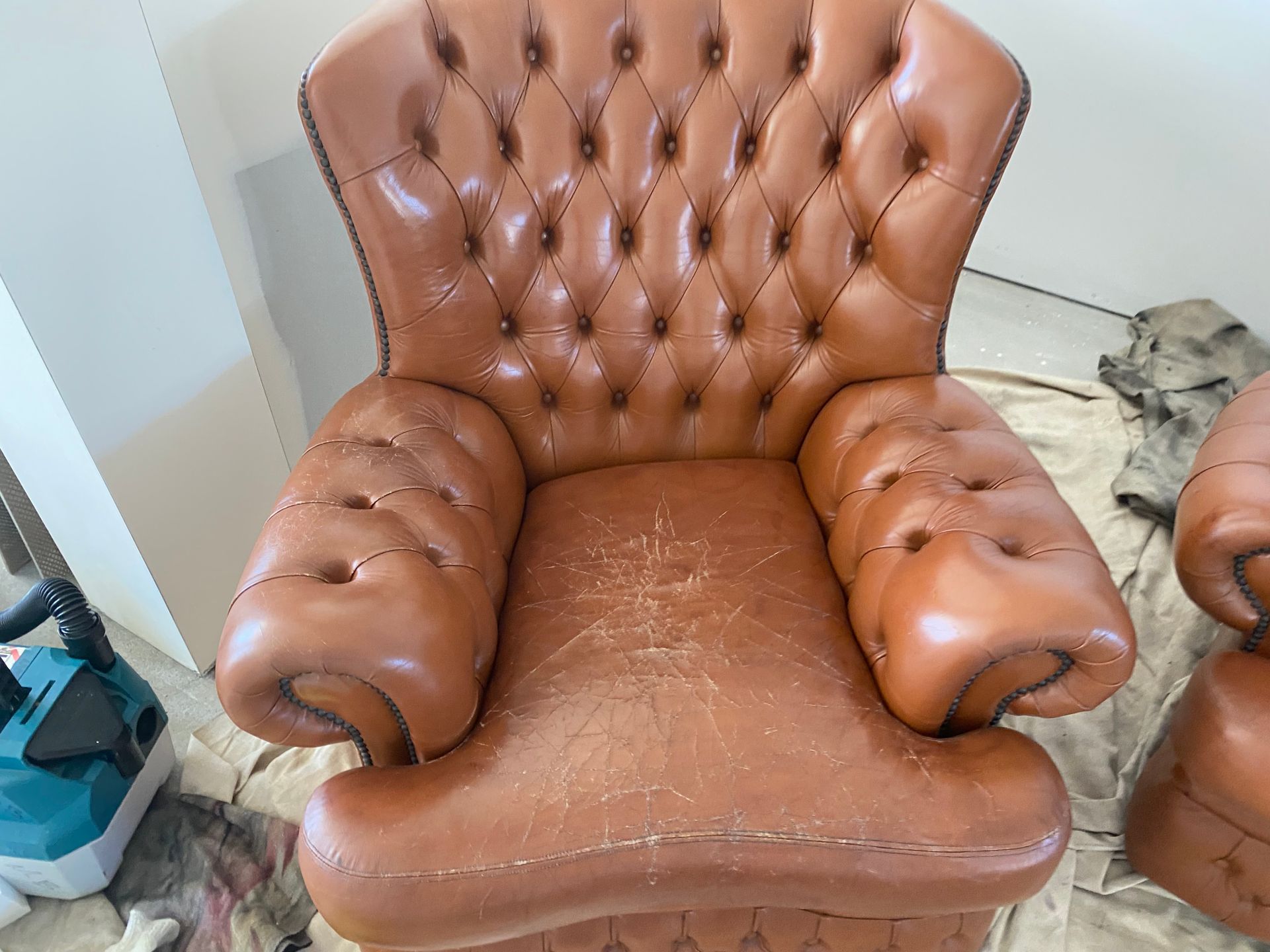 A brown leather chair is sitting on a table in a room. — Furniture & Auto Pride In Port Macquarie, NSW