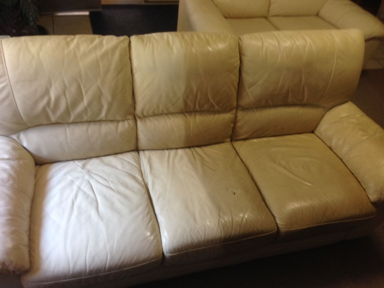 A White Leather Couch is Sitting in a Living Room — Furniture & Auto Pride In Port Macquarie, NSW