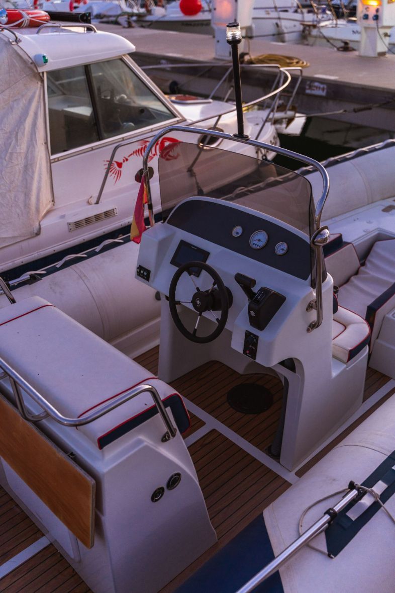 A White Boat With a Steering Wheel and Seats — Furniture & Auto Pride In Port Macquarie, NSW